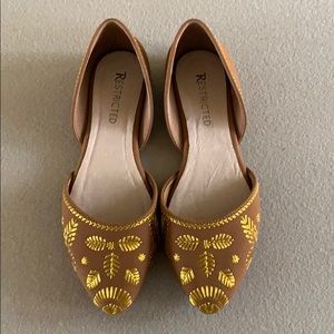 Tan and gold flats